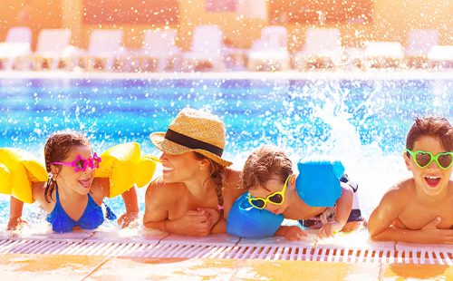 21871473 - active happy family having fun in the pool, spending time together in aquapark, summer holidays, joy and pleasure concept